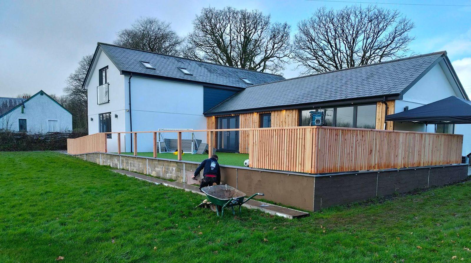 Modern single-storey extension with timber cladding and slate roof