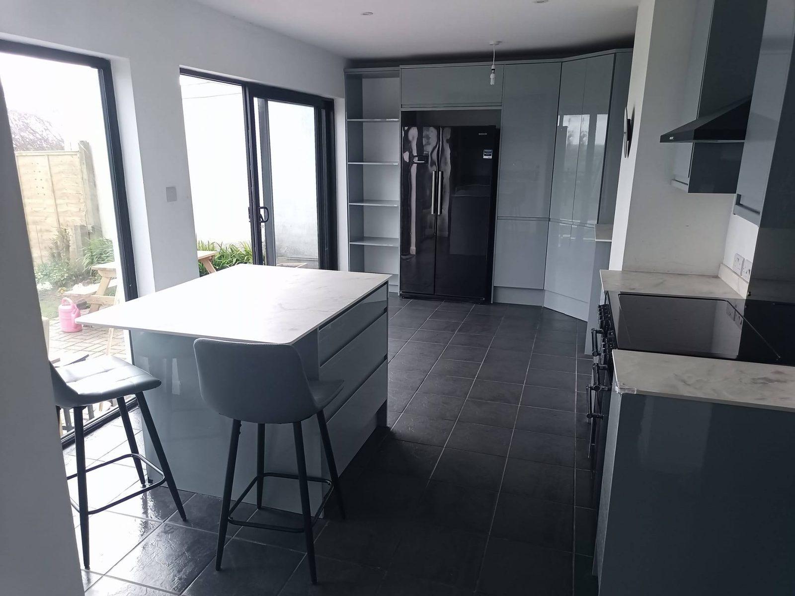 Modern grey gloss kitchen with island and bifold doors
