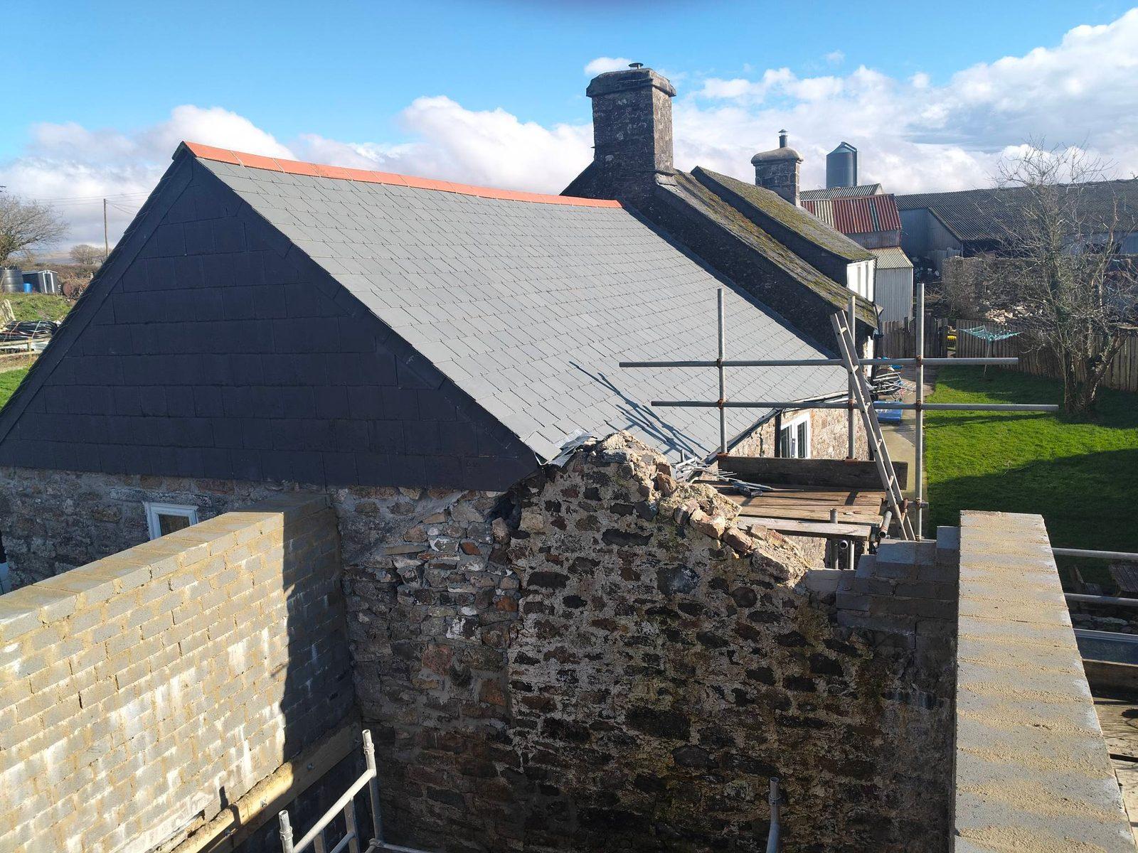 Slate roof repair with new ridge tiles