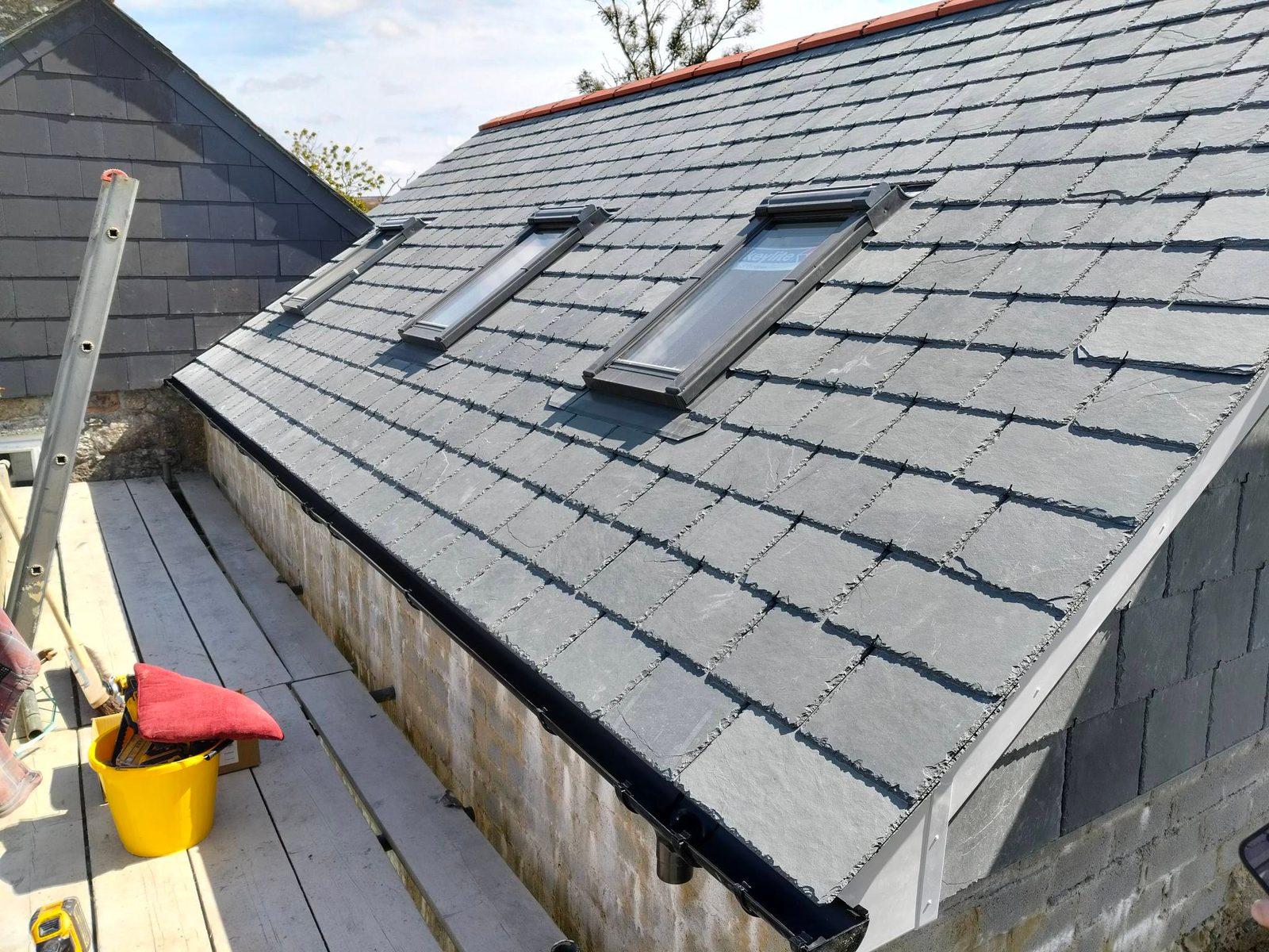 Completed grey slate roof with twin rooflights