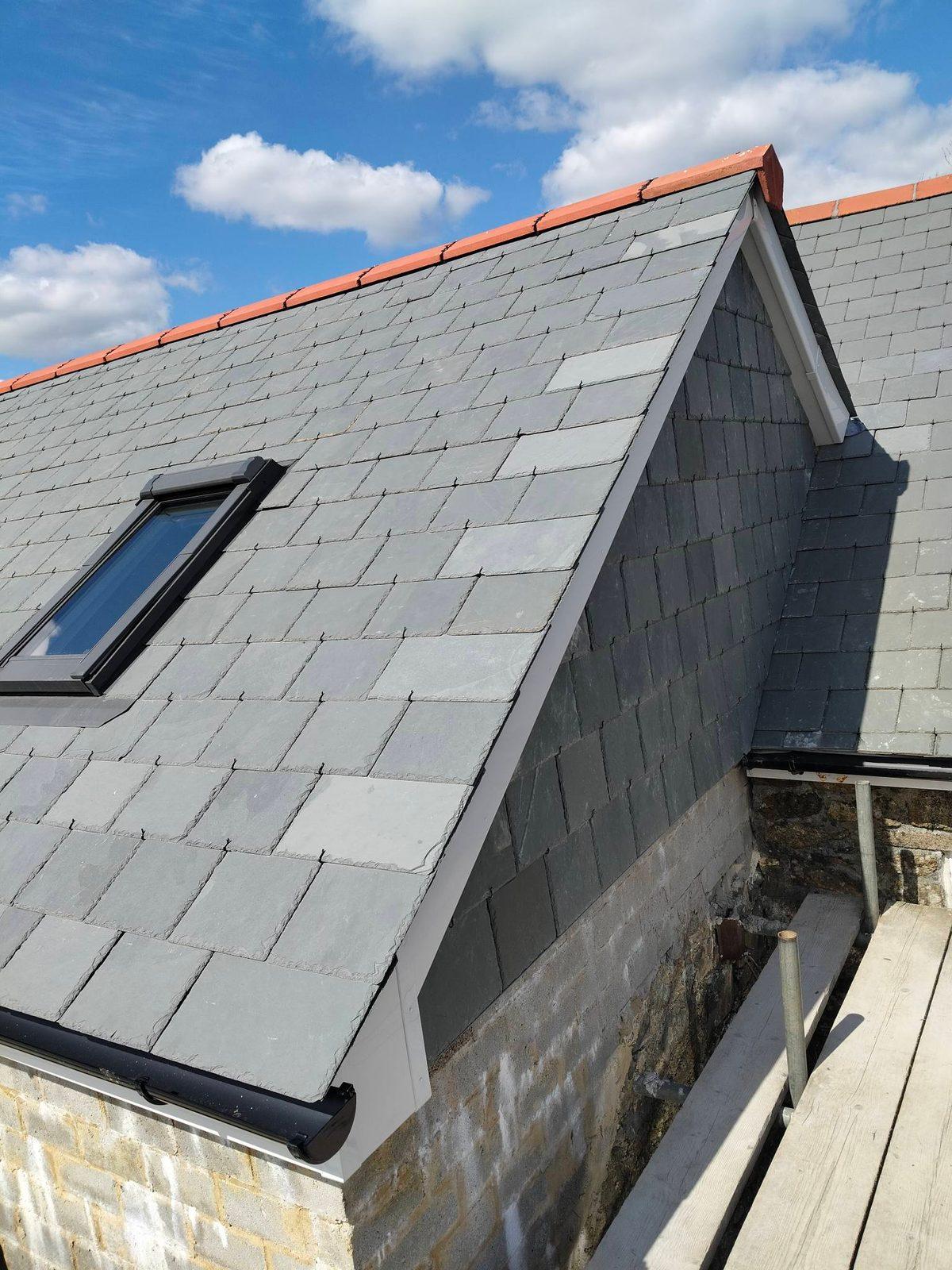 New slate roof gable with terracotta ridge tiles