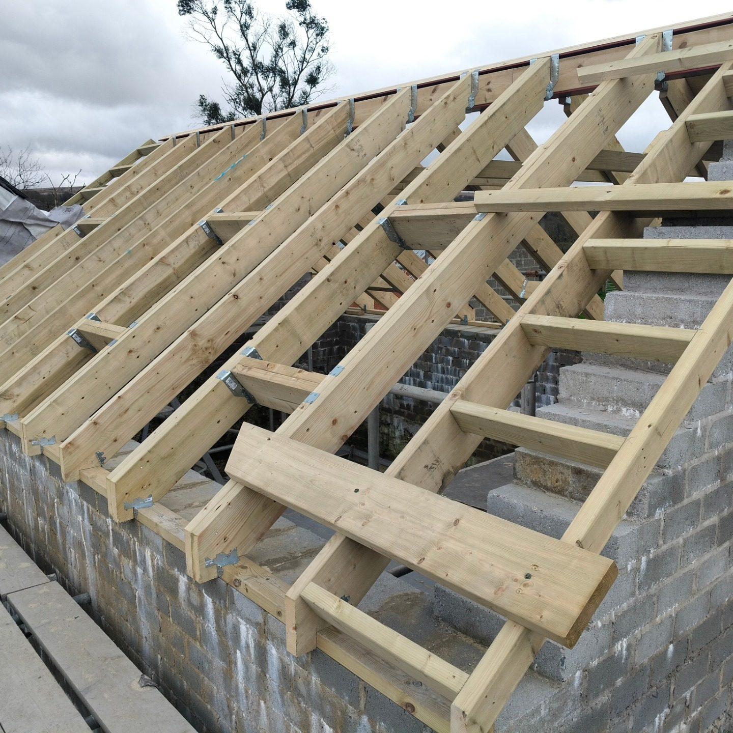 New timber roof rafters over a blockwork wall during a re-roof